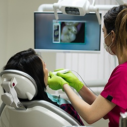 Dentist and patient looking at intraoral photos