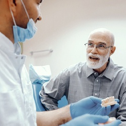 senior man asking his implant dentist in Sagamore Hills about All-on-4