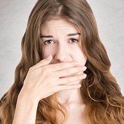 Woman covering her mouth