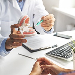 Sagamore Hills dentist showing patient model of teeth