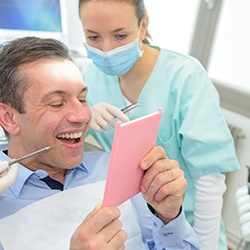 Man checking dental crown in Sagamore Hills