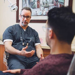 Dentist talking to patient