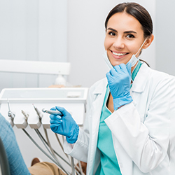 Emergency dentist in Sagamore Hills smiling while treating patient