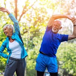 couple stretching outside before exercising