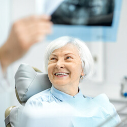 Smiling woman having an implant consultation