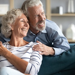 Couple smiles with implant dentures in Sagamore Hills