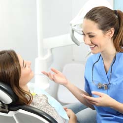 woman talking to her dental hygienist