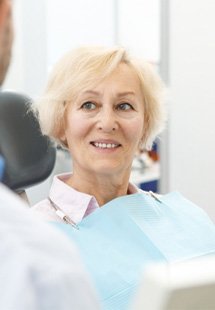 patient smiling while talking to dentist