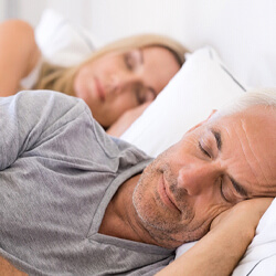 Man in a gray shirt sleeping