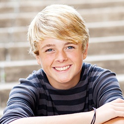 Young boy smiling on steps