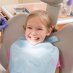 Smiling girl in dental chair