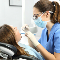 A dental hygienist doing a dental cleaning