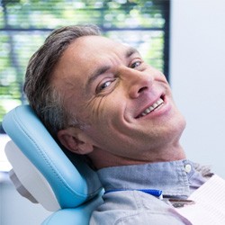 Male patient leaning back in chair and smiling