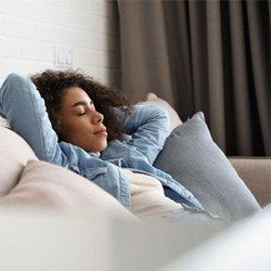 Young woman resting at home on couch
