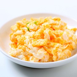 A serving of scrambled eggs in a bowl