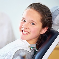 Smiling girl in dental chair