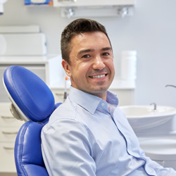 Man sitting in dental chair smiling