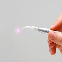 Hand holding soft tissue laser wand
