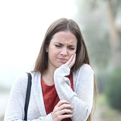 Woman touching her jaw in pain