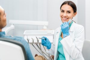 dentist smiling for early detection of oral health issues
