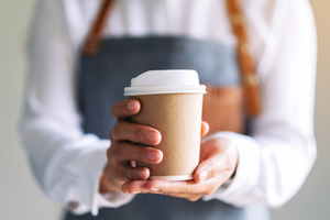 Barista holding a cup of coffee